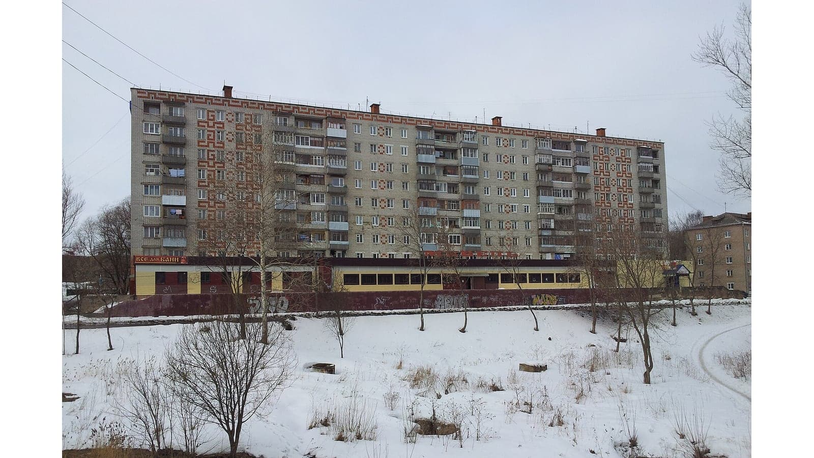 Девятиэтажный кирпичный жилой дом с узорами на торцах в Рыбинске